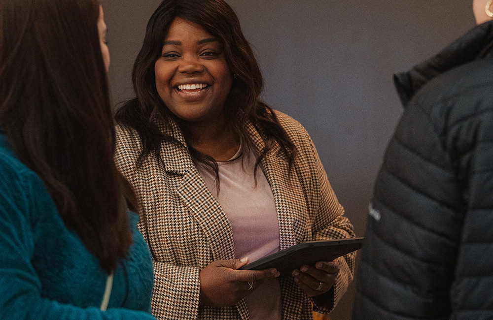 Woman smiling holding tablet