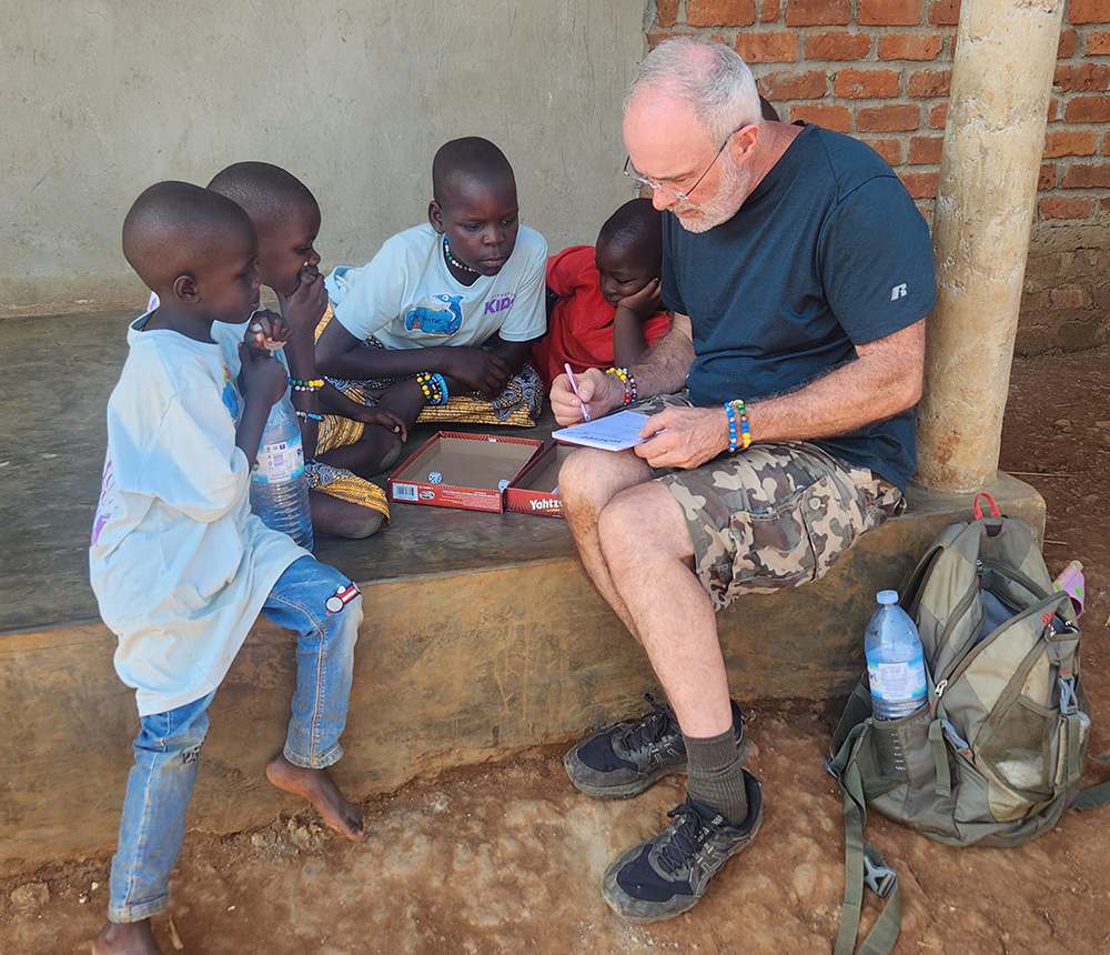 man playing yahtzee with young boys