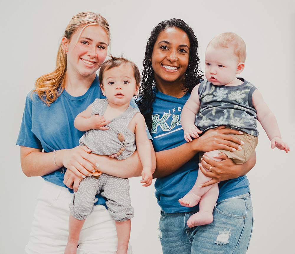 teenage girls holding babies