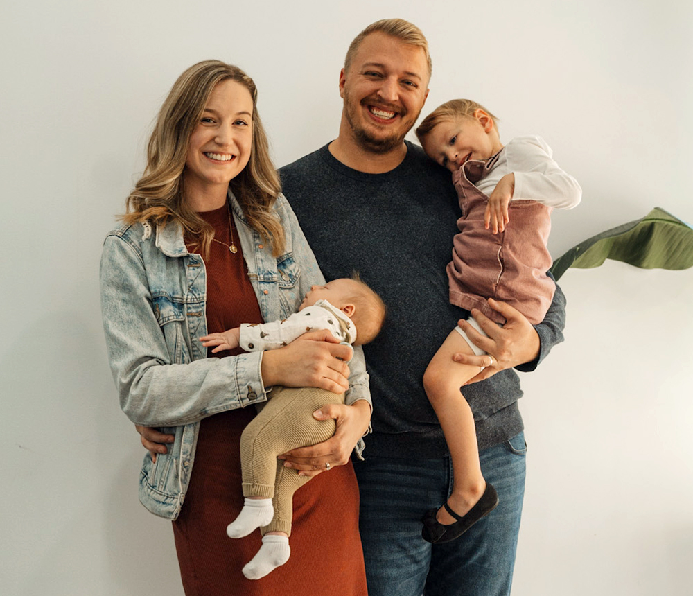 parents posing with children before baby dedication