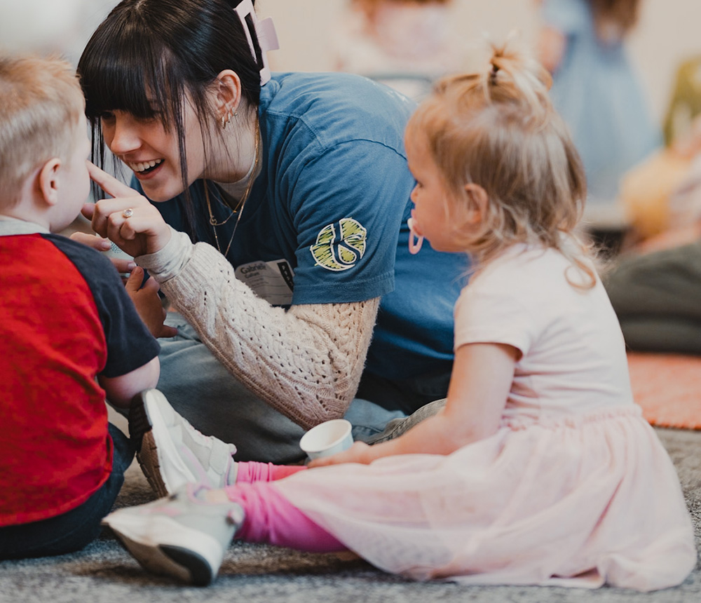 young woman playing with toddlers