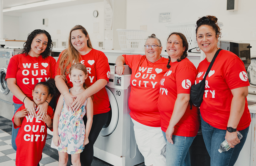 women smiling at laundry outreach